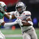 Dec 16, 2023; Atlanta, GA, USA; Howard Bison running back Eden James (5) stiff arms Florida A&M Rattlers defensive back Deco Wilson (11) in the first half at Mercedes-Benz Stadium.